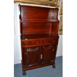 Mahogany waterfall bookcase with cupboard doors and carved claw feet