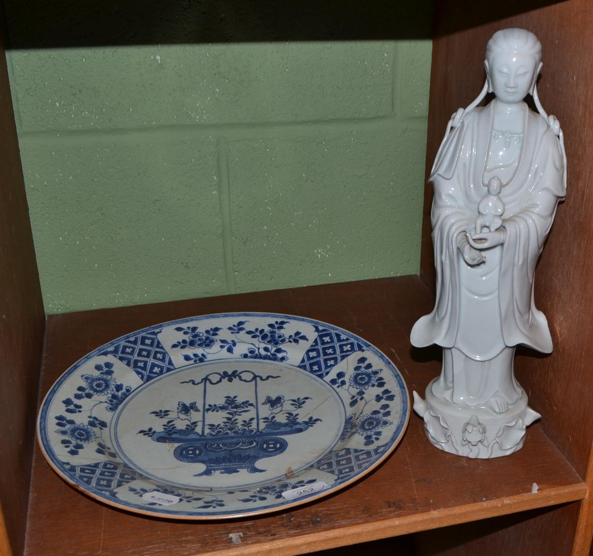 A 19th century Chinese Blanc De Chine figure of Guanyin and a Chinese porcelain dish, K'ang Hsi (a.