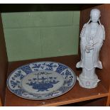A 19th century Chinese Blanc De Chine figure of Guanyin and a Chinese porcelain dish, K'ang Hsi (a.