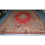 Saroukh carpet, West Persia, the plain crimson field centred by a floral medallion framed by