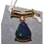 A 9ct gold opal and diamond pendant, a triangular black opal in a yellow claw setting on a shaped