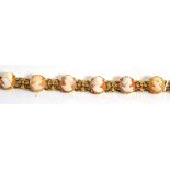 A cameo bracelet, the oval cameos alternate with floral links, length 19cm