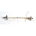 An old cut diamond bar brooch, a knife edge bar with a fleur-de-lys style diamond set motif at