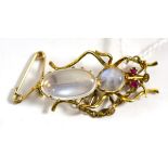 A ruby and moonstone inset brooch, ruby eyes and two moonstones make up the body, length 3.4cm