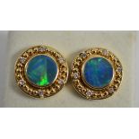 A pair of opal doublet and diamond earrings, the round opal triplet in a yellow collet setting, to a