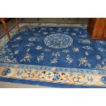 Chinese carpet, the mid indigo field with central roundel surrounded by plants, framed by