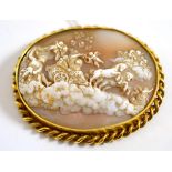 An oval cameo brooch, carved with a classical scene including a chariot pulled by rearing horses,