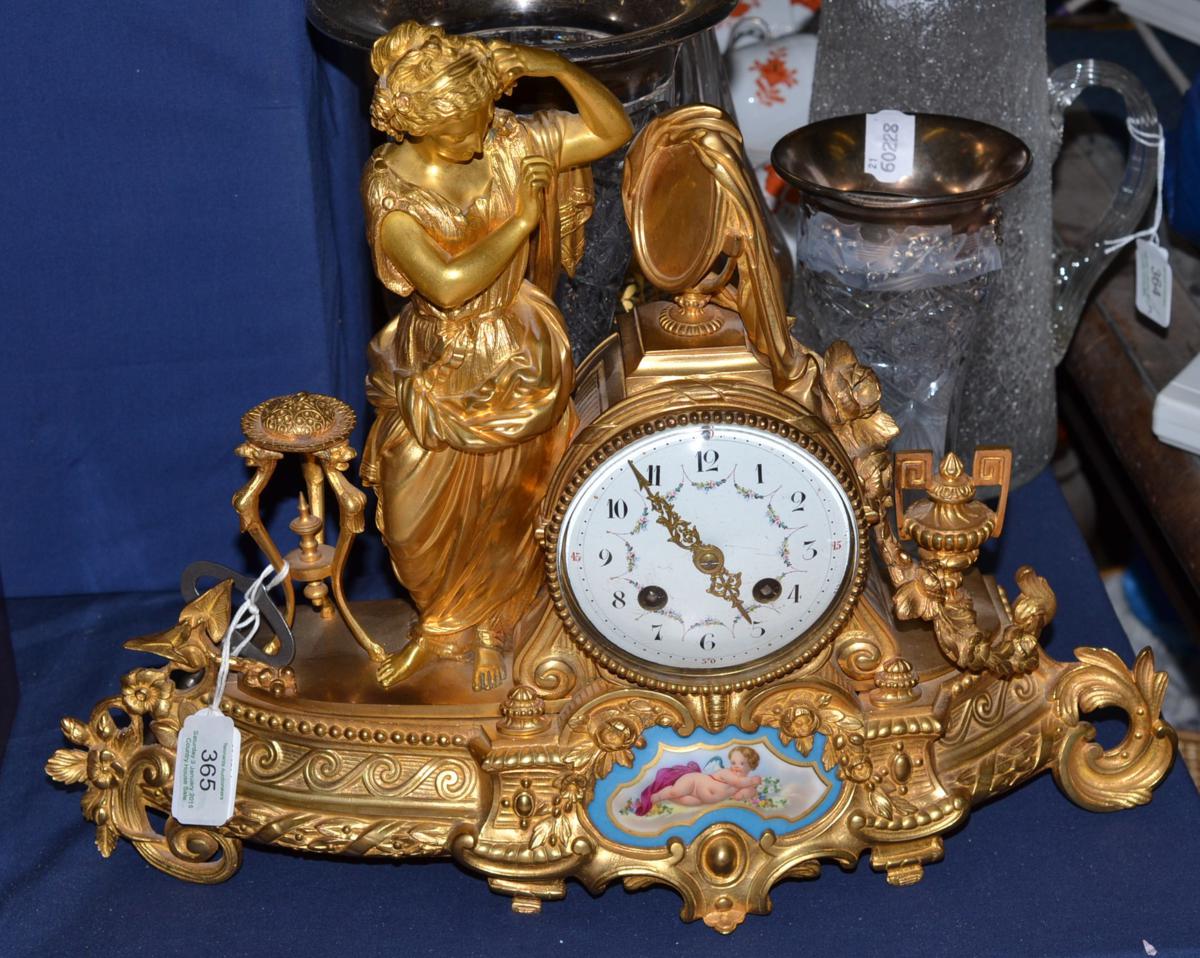 A gilt metal striking mantel clock, circa 1890, case depicting a classical figure in robes, floral