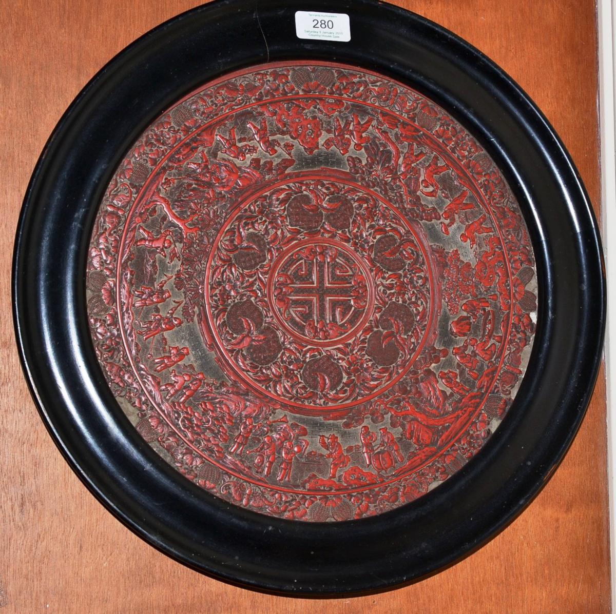 An 18th/19th century Chinese cinnabar lacquer circular panel (a.f.), 31cm diameter (excluding frame)