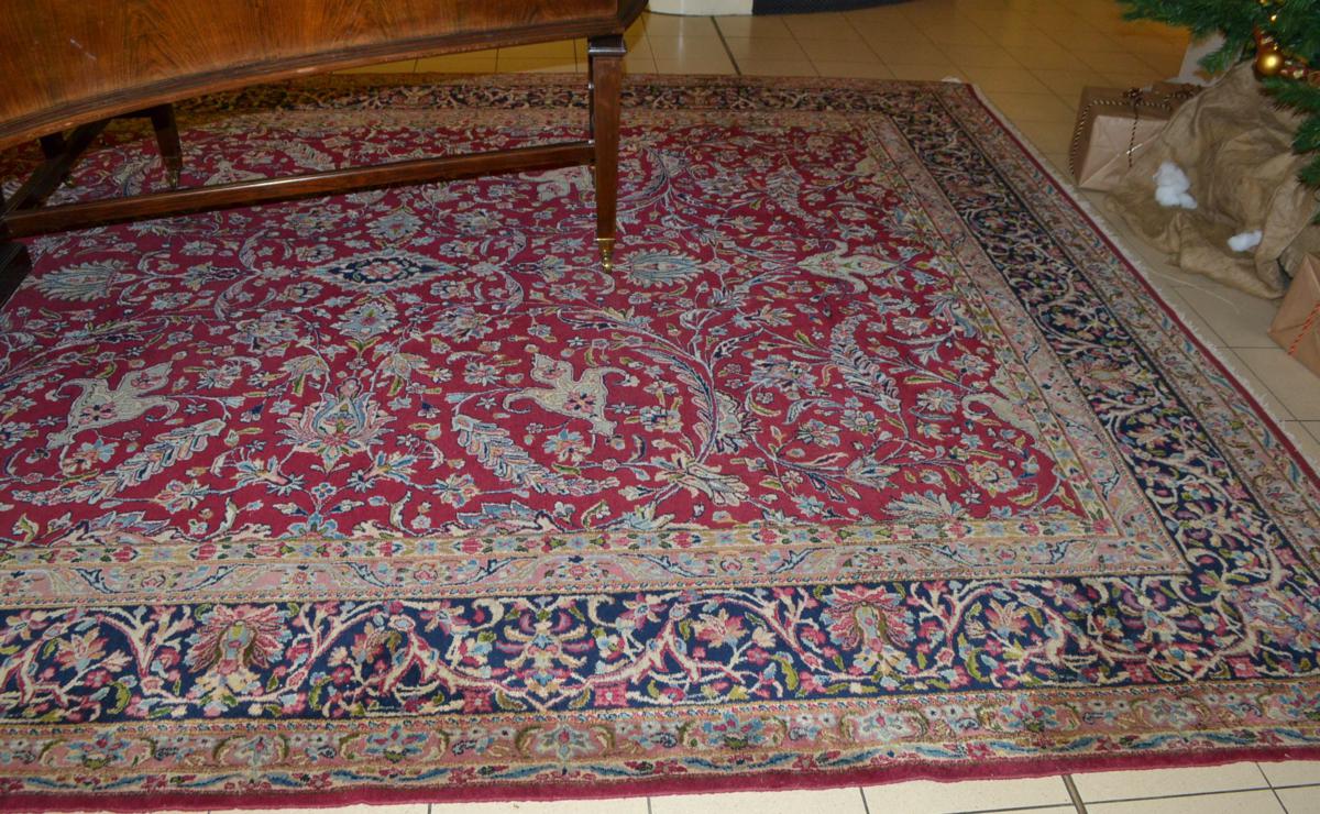 Kirman carpet, South East Persia, the raspberry field of scrolling vines around a floral medallion