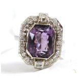 An amethyst and diamond cluster ring, an octagonal brilliant cut amethyst within a border of eight-