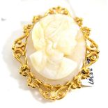 A 9ct gold opal cameo brooch/pendant, carved as a maiden, with a flower in her hair, in a scroll