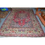 Yazd carpet, South East Persia, the raspberry field centred by an indigo pole medallion framed by