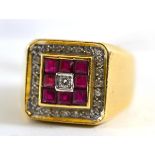 A gentleman's diamond and ruby ring, a central round brilliant cut diamond is bordered by a row of