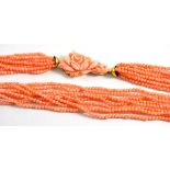 Coral necklace, multi strand coral beads strung to a carved floral clasp, length 63.5cm