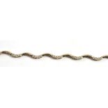 An 18ct gold diamond bracelet, of wavy form, alternating links set with round brilliant cut