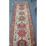 Narrow Tabriz runner, Persian Azerbaijan, the ivory field with a column of medallions enclosed by