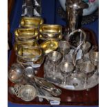 Ten silver plated and gilt salts engraved with a crest, silver plated egg cups on tray, plated spill