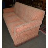 Three seater feather filled orange patterned sofa