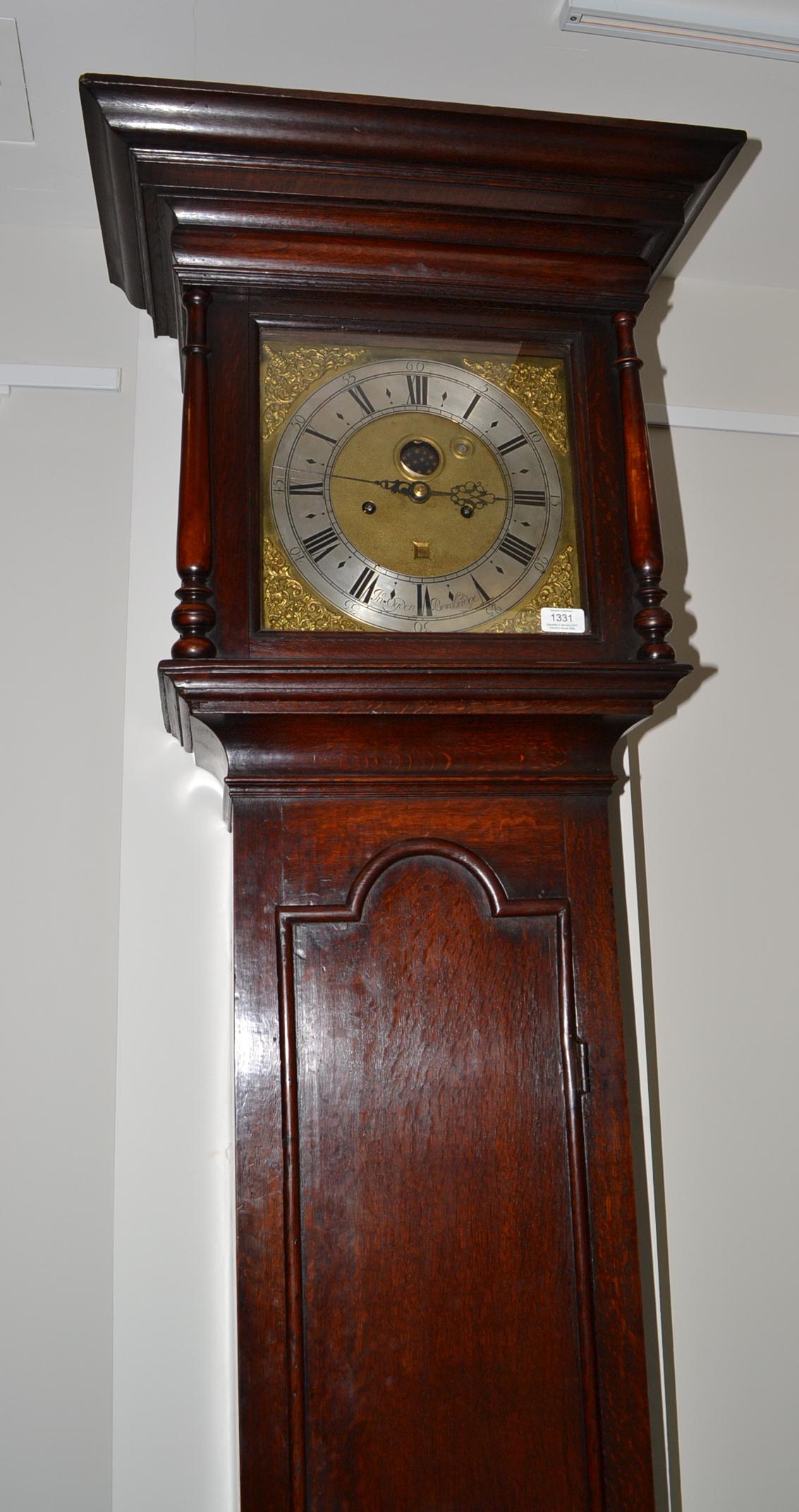 An oak eight day longcase clock, caddied pediment, double D-ended moulded trunk door, glazed
