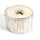 A George III silver tea caddy with ribbed sides and floral finial (repaired hinge), London 1787, 9cm