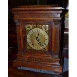 An oak chiming table clock, circa 1890, glazed side panels, 6-inch dial, two dials for fast/slow and