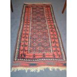 Balouch rug, Persian/Afghan Frontier, the indigo honeycomb lattice field enclosed by stylised