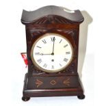 A mahogany table timepiece, circa 1830, arched top, front with applied mounts and brass inlay, 5-