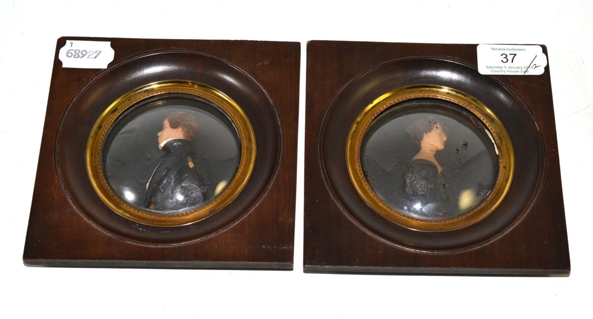 Pair of Italian wax miniature portraits of a young gentleman and woman, in fruitwood frames with