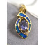 An opal doublet, diamond and iolite pendant, an oval cut iolite in a yellow claw setting spaced to a