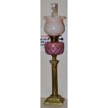 A Victorian brass oil lamp with pink reservoir, 70cm high