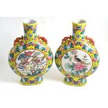 A pair of late 19th century Chinese famille jeune porcelain moon flasks, 30cm high