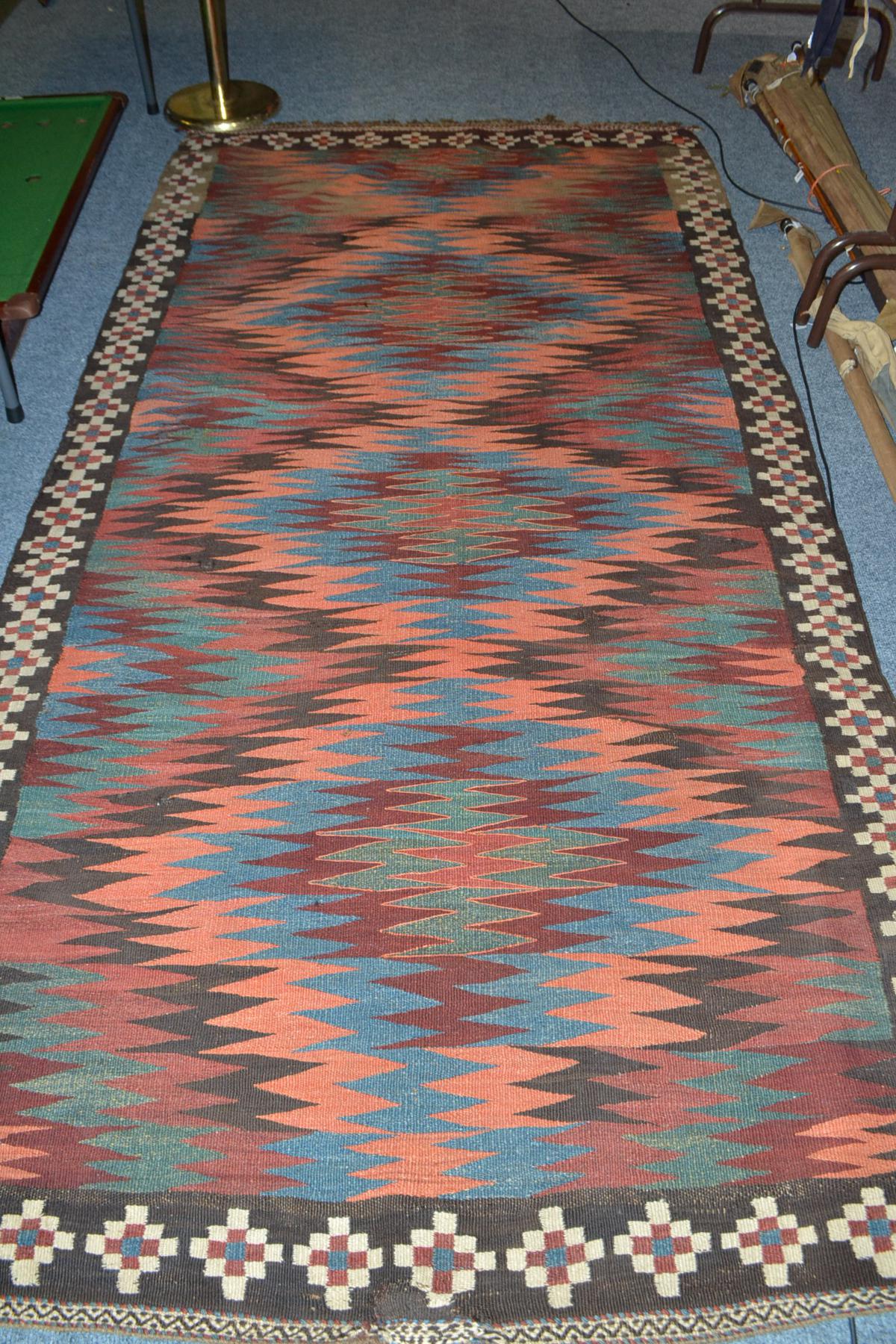 Veramin kilim, Central Persia, the field of interlinking polychrome serrated medallions enclosed