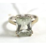 A 9ct white gold pale mint green amethyst ring, the scissor cut mint green stone in a double corner