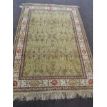 A silk rug, probably Kashmir North West India, the olive green field of flowering vines enclosed