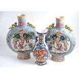 A pair of Chinese famille rose moon flask vases, height 31cm together with a Chinese polychrome