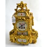 ^ A gilt metal and porcelain striking mantel clock, circa 1890, turquoise and gilt decorated