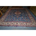 Mashad carpet, Khorasan, the mid indigo field of floral vines centred by an ivory medallion framed