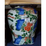 A Chinese famille verte large vase painted with a phoenix and kylin on a fence veranda near rocks,