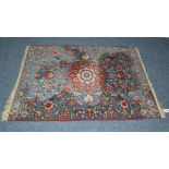 Unusual Isfahan carpet, Central Persia, the pale indigo field with flowerhead medallions flanked