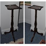 Pair of mahogany torcheres with fluted supports and scrolled toes