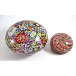 ^ A large glass paperweight decorated with flowers and canes, diameter 20cm, together with a smaller