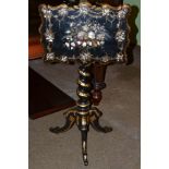 A Victorian papier mache occasional table with tilting top, barley twist column, gilt highlights and