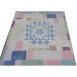 Early 20th Century Quilt with pale blue central appliqued flower head, incorporating plain and