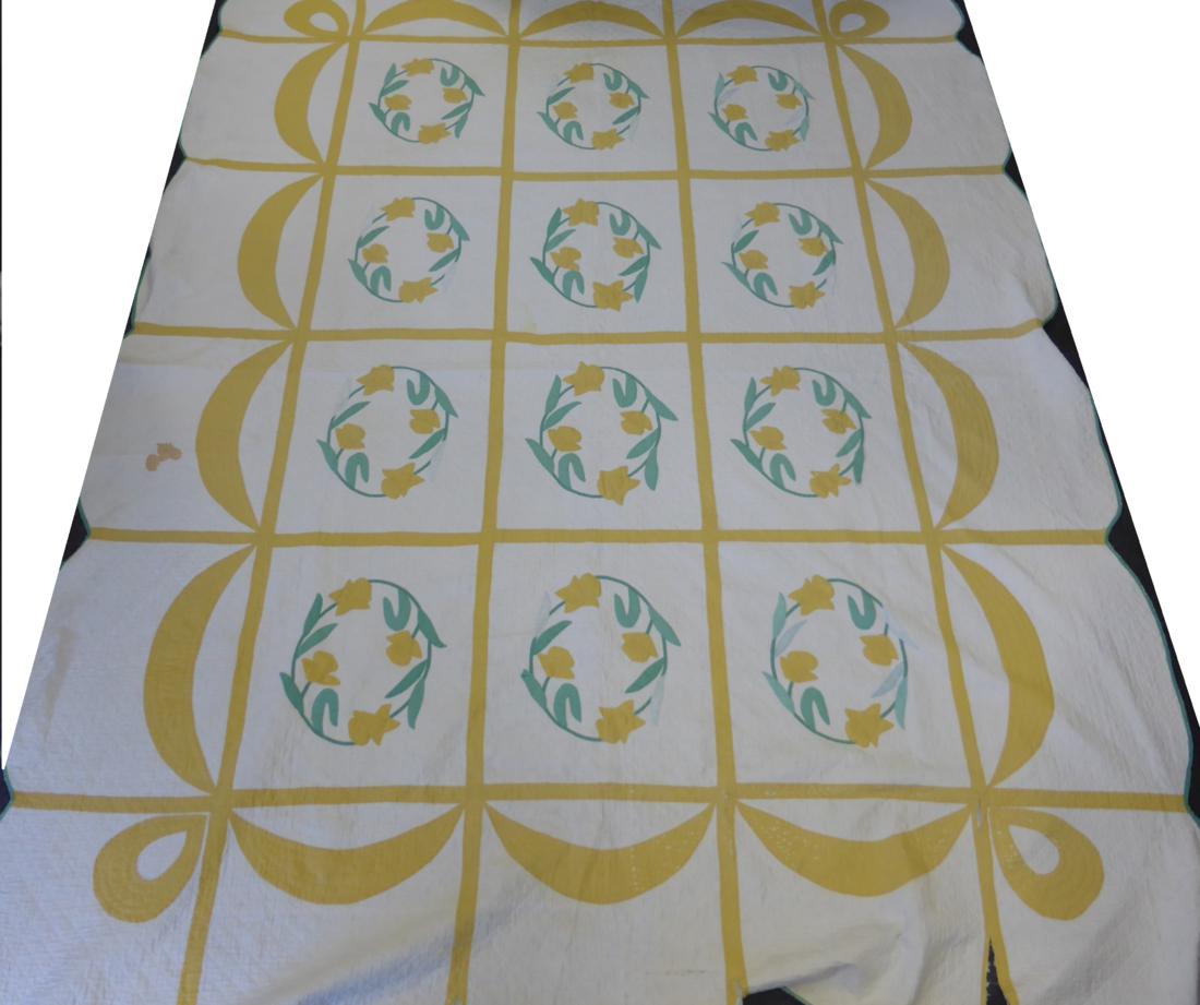 An Early 20th Century Quilt appliqued with circular daffodil floral motifs, within a yellow