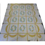 An Early 20th Century Quilt appliqued with circular daffodil floral motifs, within a yellow