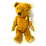 A Circa 1930's Cinnamon/Dark Yellow Jointed Teddy Bear, with glass eyes, vertical stitched nose,