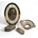 An oval silver frame, small silver pierced dish, silver snuff box and a small silver box (4)