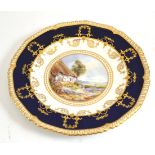 A Royal Crown Derby plate, depicting a cottage scene