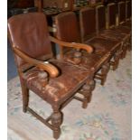 A set of eight 1920s oak dining chairs with close nailed leather seats